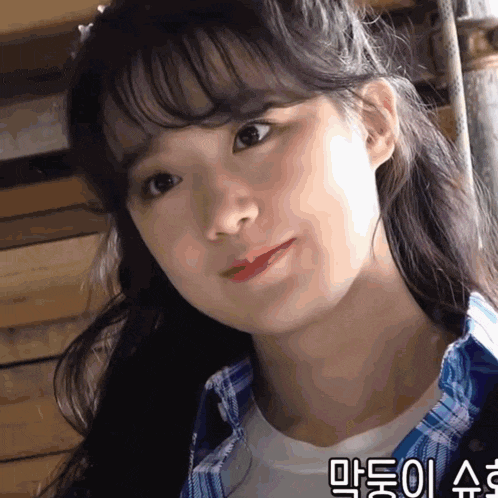 a close up of a girl 's face with korean writing on the bottom right