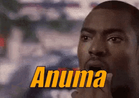 a close up of a man 's face with the word anuma written in yellow