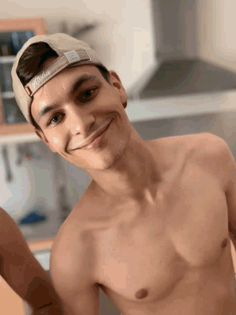 a shirtless man wearing a hat that says athena