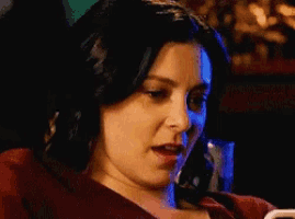 a woman with her eyes closed is looking at something