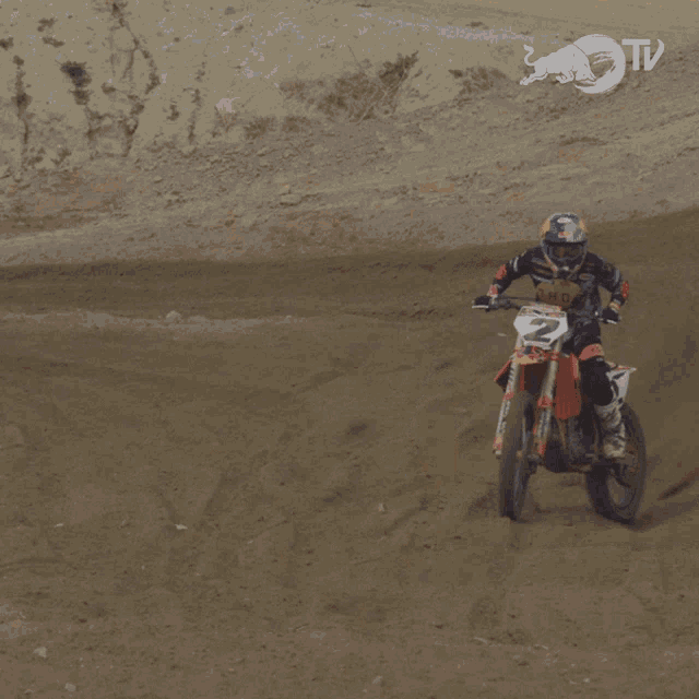 a person on a dirt bike with the number 2 on it