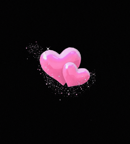 two pink hearts are surrounded by a circle of lights