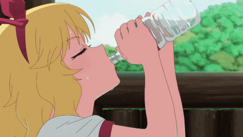 a girl drinking water from a plastic bottle with a bow on her head