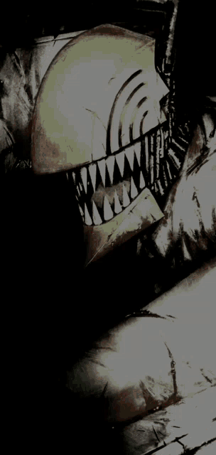 a close up of a person 's face with sharp teeth and a helmet .