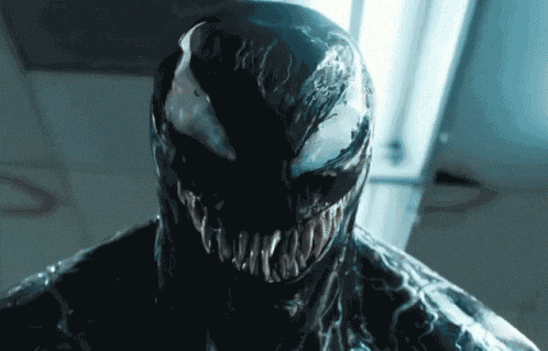 a close up of venom 's face and mouth with sharp teeth