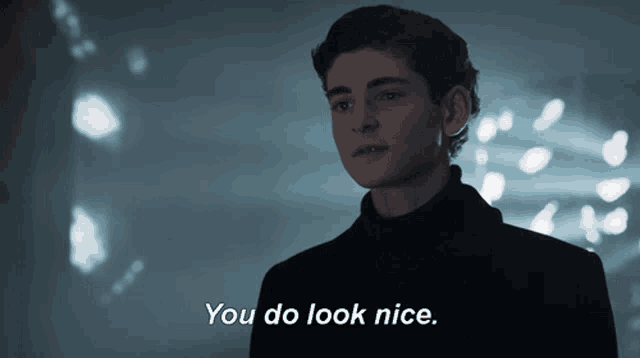 a young man in a black coat says you do look nice