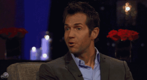 a man in a suit and blue shirt is sitting in front of a microphone on abc