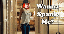 a woman walking down a hallway with the words " wanna spank me " written on the bottom