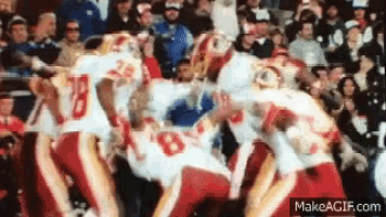 a group of football players are playing a game and one of them has the number 28 on his jersey