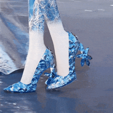 a woman wearing a pair of blue and white shoes