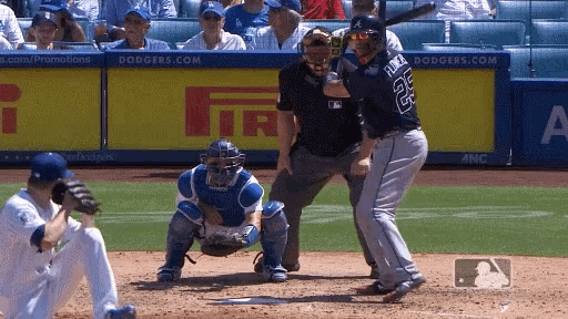 a baseball player with the number 26 on his back swings his bat