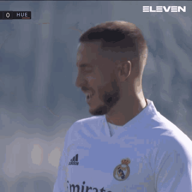 a blurred image of a soccer game with the score at 0 hue