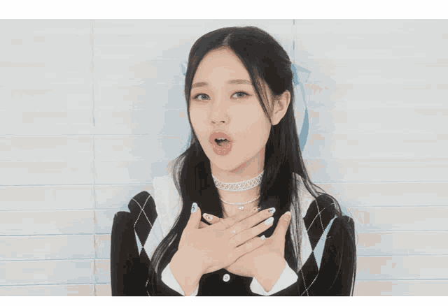 a girl with long black hair wearing a choker and cardigan