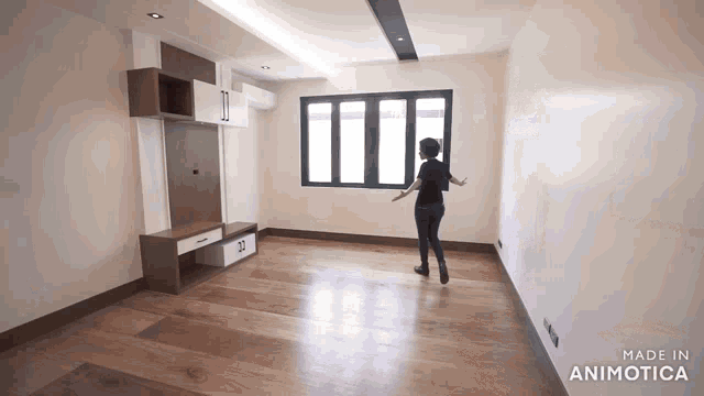 a woman is standing in an empty room with the words made in animotica on the bottom