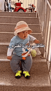 a baby wearing a hat is sitting on a set of stairs