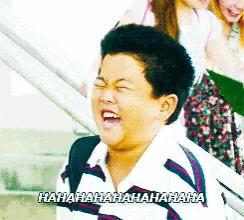a young boy is laughing with the words hahahaha written on the bottom