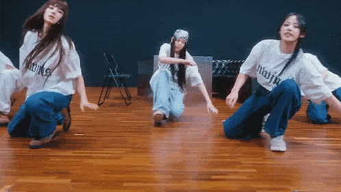 a group of young women are dancing and one of them has a shirt that says majin