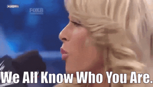 a woman says we all know who you are in front of a microphone