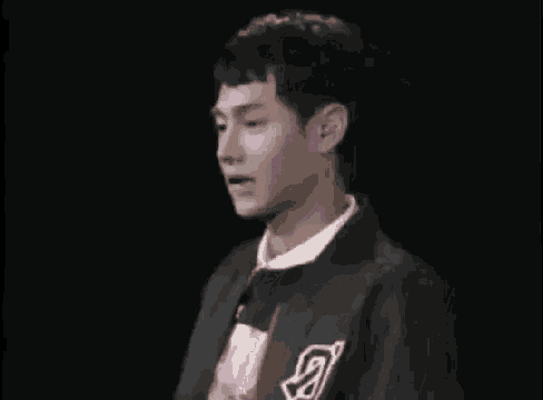 a young man is holding a pink cotton candy in his hand .