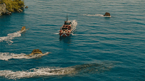 a small red and white boat is floating in the ocean