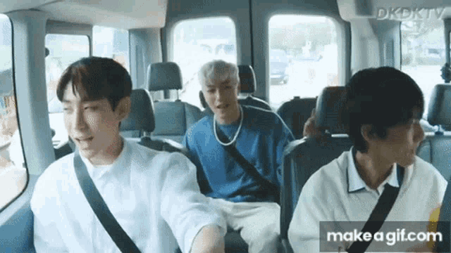a group of young men are sitting in the back of a van .