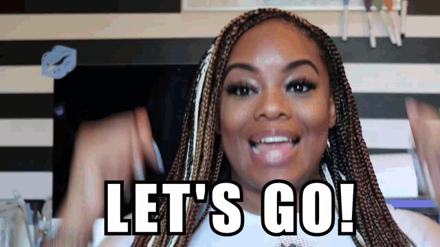 a woman with braids says let 's go and smiles