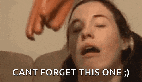 a woman with her eyes closed and a hand pointing at her face .