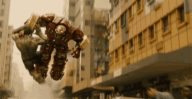 a hulk and a robot are fighting in a city