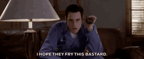 a man is sitting on a couch holding a remote control and saying i hope they fry this bastard .