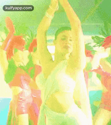 a woman in a white dress is dancing in front of a group of people .