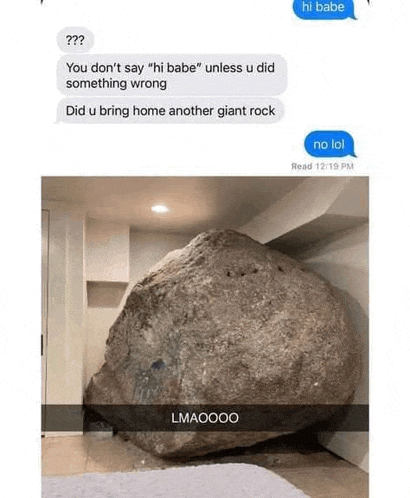 a giant rock is sitting on the floor in a room next to a text message .