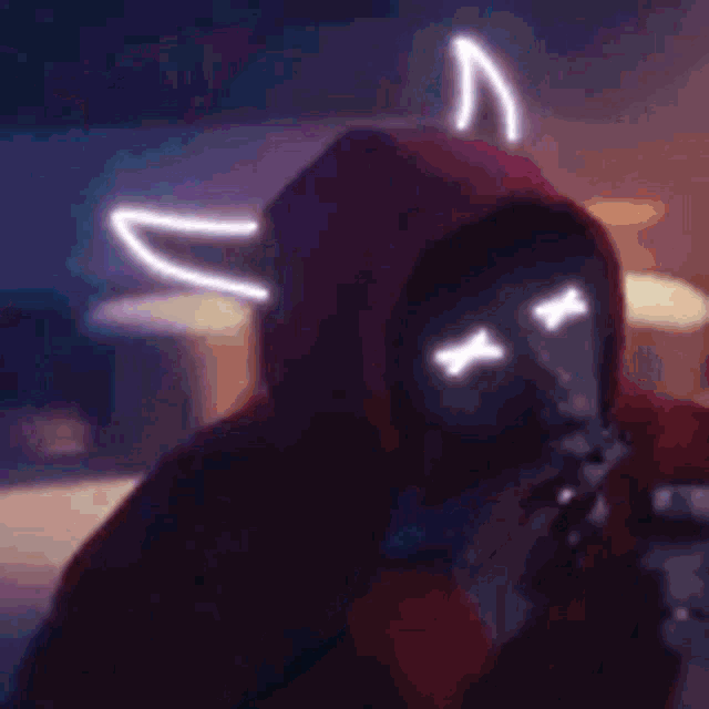 a person in a hoodie is smoking a cigarette and holding a lighter .