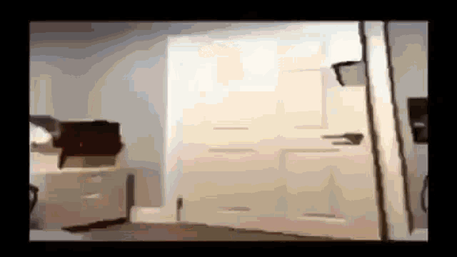 a white door is open in a room with a few boxes on the floor