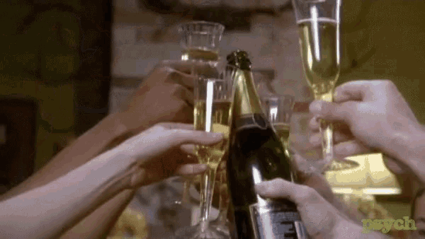 a group of people are toasting with champagne glasses and a bottle .