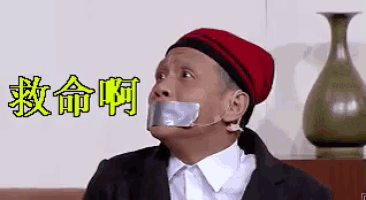 a man with duct tape on his mouth is wearing a hat and a suit .