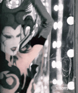 a black and white photo of a woman with the words xtecrys.com below it