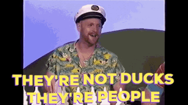 a man wearing a captain 's hat says they 're not ducks they 're people