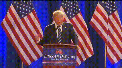 a man stands at a podium with a banner that says lincoln day 2015