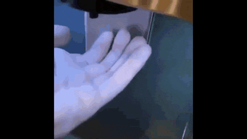 a close up of a person 's hand pressing a button on a machine .