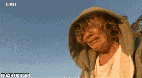 a man wearing a hooded jacket is crying in front of a blue sky with trash italiano written on the bottom right