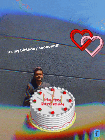 a man is standing in front of a birthday cake that says happy birthday