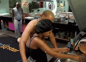 a man and a woman are cooking in a kitchen with a sign that says a star