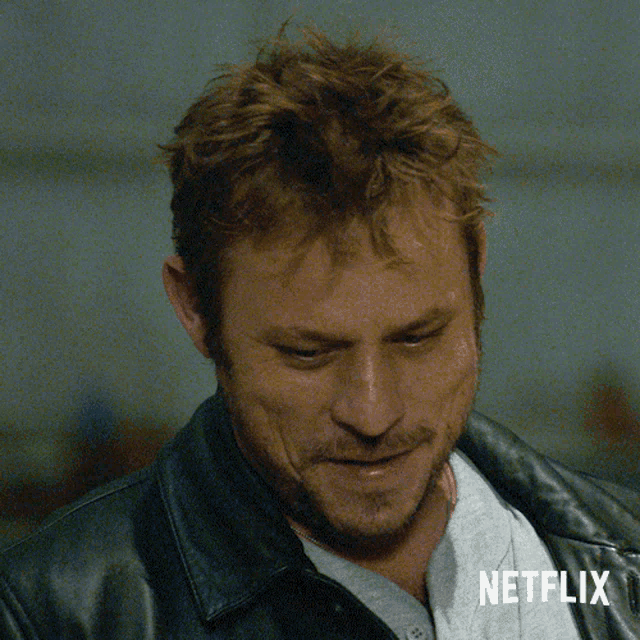 a close up of a man 's face with a netflix logo on the bottom