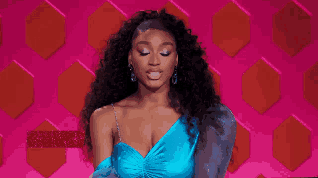 a woman in a blue dress with the name normani on the bottom right
