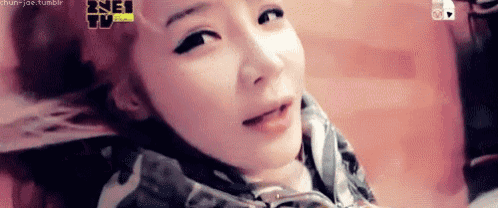 a close up of a woman 's face with a blurred background .