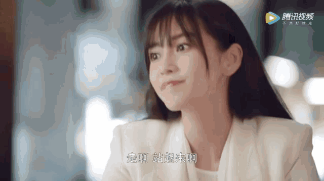 a close up of a woman 's face with chinese writing on the bottom right