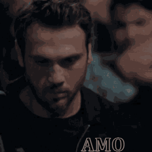 a close up of a man 's face with the word amo on the bottom right