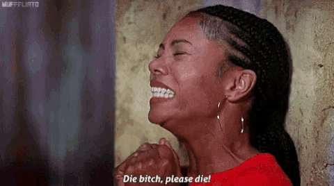 a woman is laughing and crying while holding her hands together .