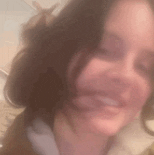 a blurry picture of a woman 's face with her mouth open .