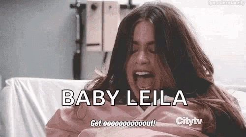 a woman is screaming in a hospital bed with the words baby leila written on the screen .